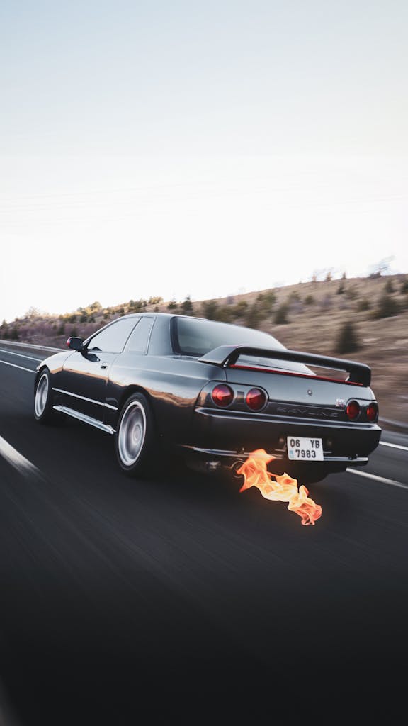 Dynamic shot of a Nissan GTR speeding on a highway in Ankara, Türkiye with flames from exhaust.